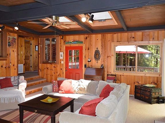 Living room steps up to guest 2 Br's, guest bath, kitchen & dining. Wrap around deck