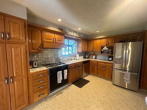 Kitchen with ample storage and dual pantries, one barely pictured to the right of the fridge.