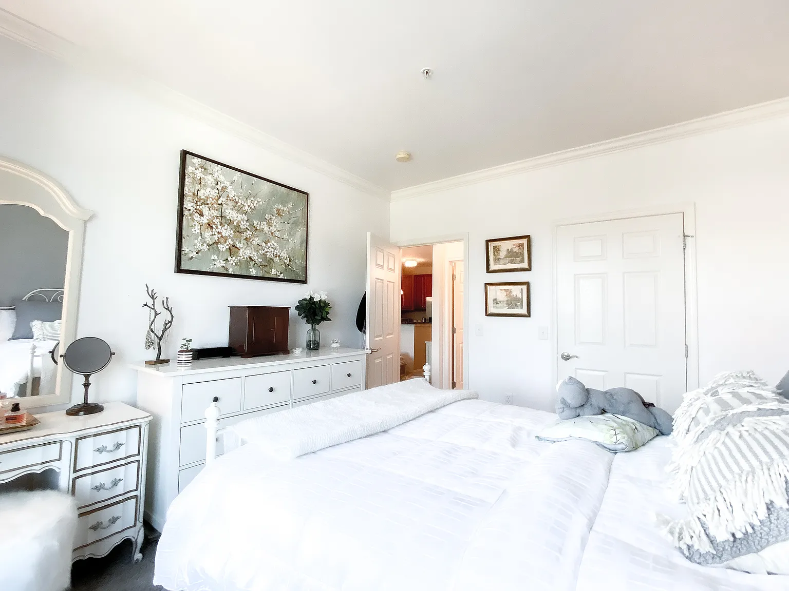 Bedroom with crown molding, bright natural light and generous closet space