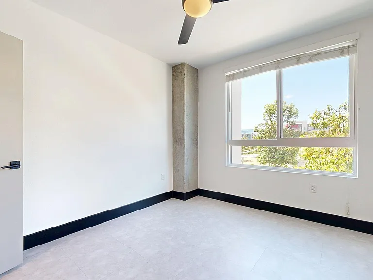 Spacious apartment Bedroom with Wood-Style Flooring.