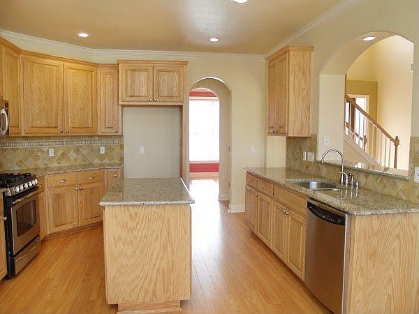Kitchen has granite counters and GE Profile Stainless Steel appliances