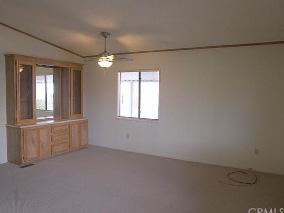 Dining area with china hutch and a new ceiling fan