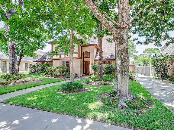 Another view of the front door and tudor style home.