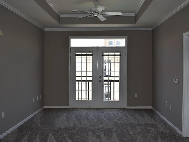 Open Living room with tray ceiling.