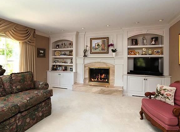 Gorgeous custom fireplace with marble surround, beautiful mantel, built-in bookcases and recessed lighting - incredible millwork!