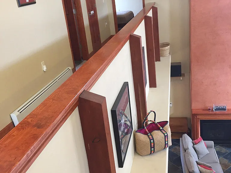 Second floor hallway to bedrooms and bath. Overlooks living room.