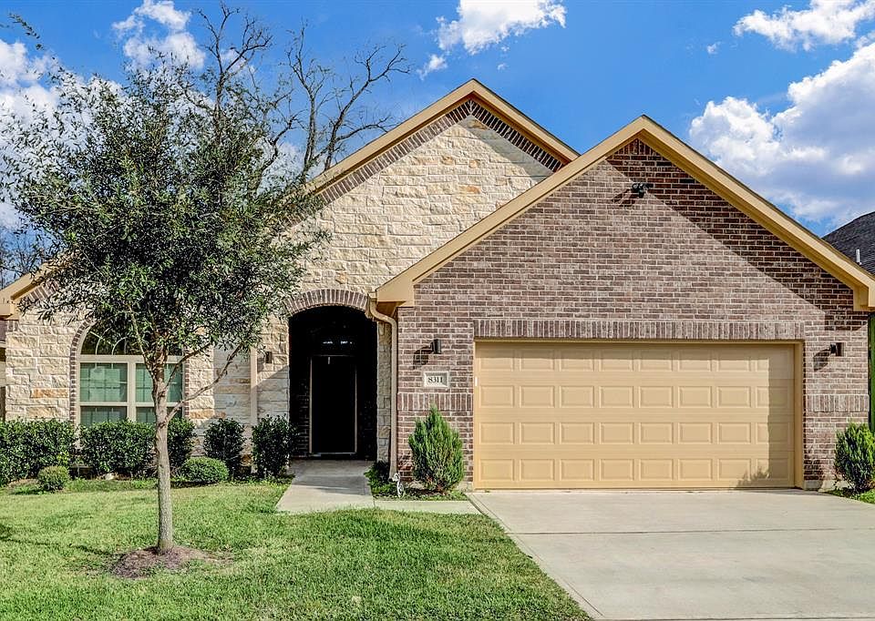 Rare 4 bedroom stone and brick facade with a full double wide driveway