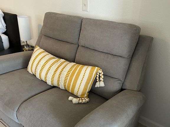 Comfortable accent chair with a stylish cushion for relaxing and unwinding.