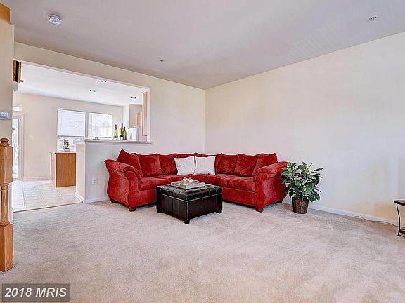 Warm and welcoming living room opens to lg kitchen