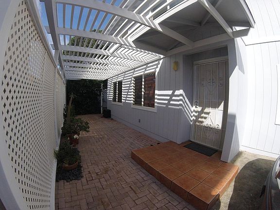 Entrance with Security Screen Door and  Bricked Patio with P