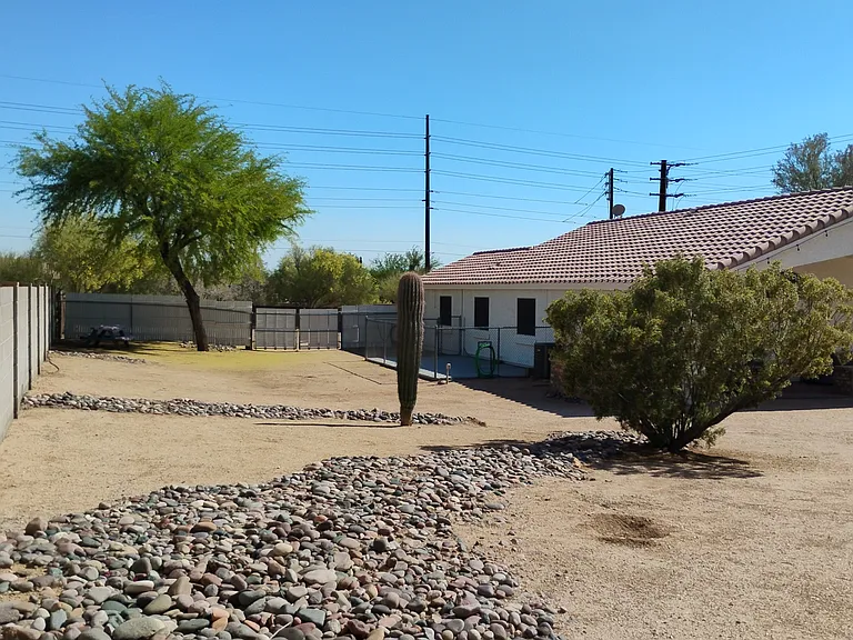 Rear area. Majority of river rock will be removed June 2025.