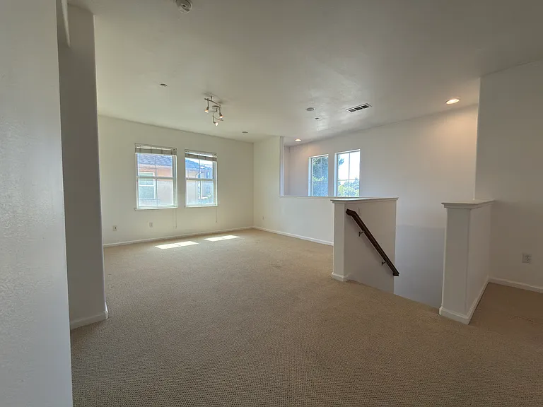 Living Room + Stairs To Garage