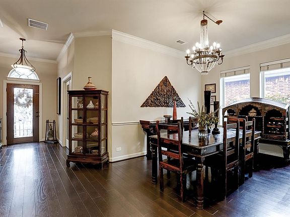 You will enter the home through the full leaded glass front door with transom window into the open concept dining room that all have rich hardwood floors.