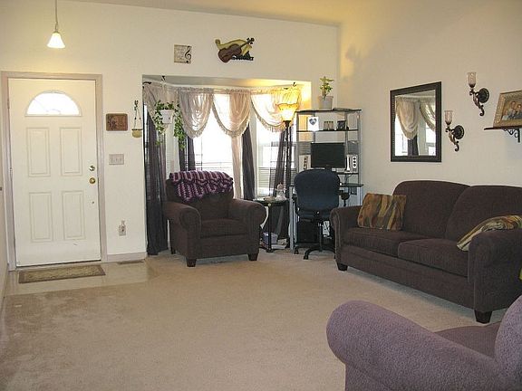 Great Room with vaulted ceilings, display niche and a large bay window 