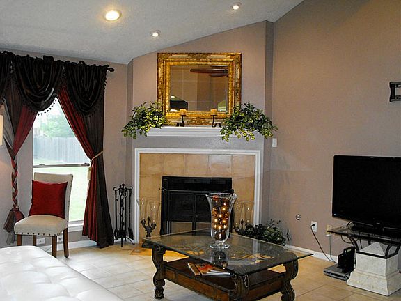Living area with gaslog fireplace, pitched ceiling