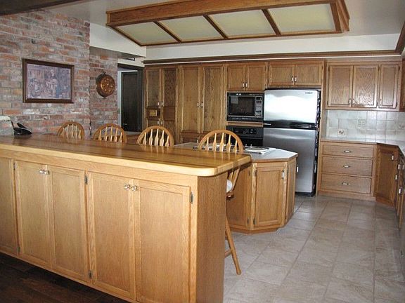 Spanish tile floor in large, chef-sized kitchen. Loads of cabinets and great views of lake.