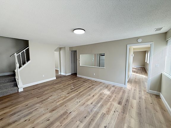 LEFT FAMILY / DINING ROOM - PASS THROUGH TO KITCHEN & STAIRS TO UPSTAIRS BEDROOMS HALL BATH & LAUNDRY HOOK UPS