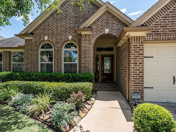 Guests are protected from the elements by the home's inviting covered front alcove.