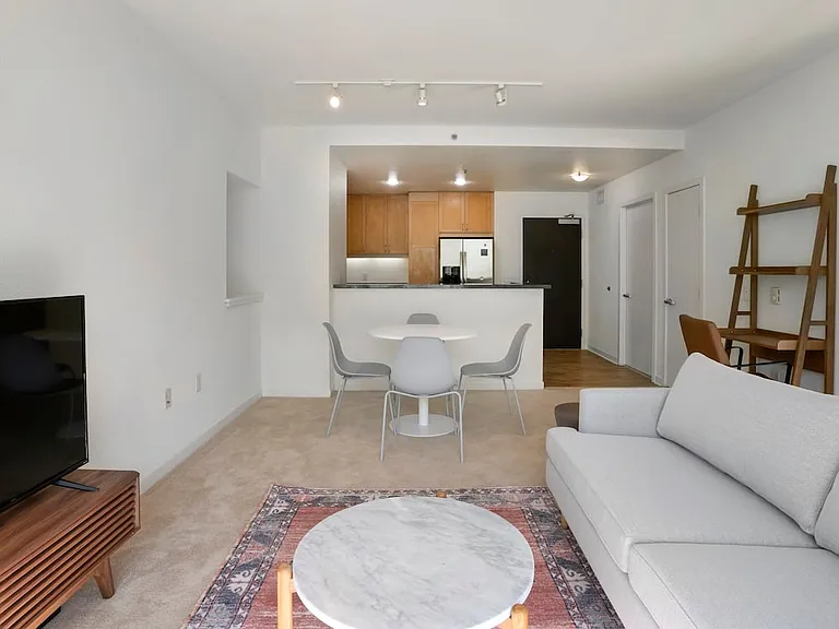 Furnished+ apartment homes come outfitted with a sofa, side chair, side table, coffee table, TV stand and 50" Television (Representative Image exact items and style of furnishings may vary)