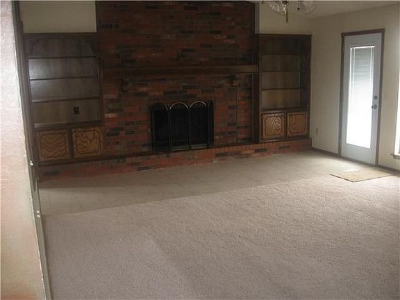 Large living with cathedral ceilings, fireplace and plenty of storage