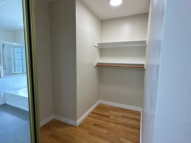 Large walk in closet w mirrored doors