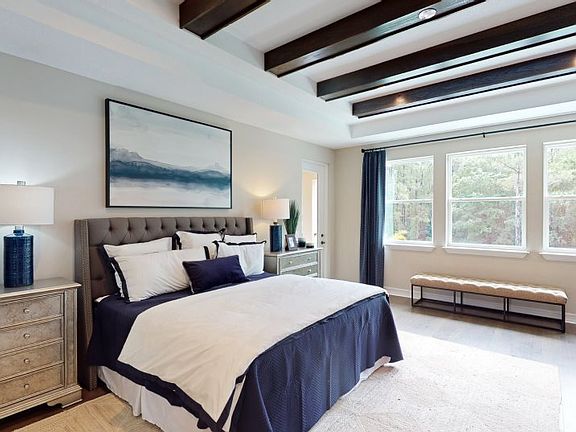 Access to a serene covered balcony makes the owner s suite a luxurious at-home getaway that also fea