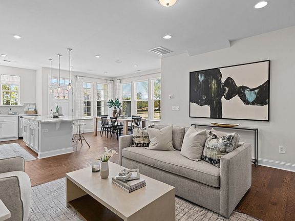 Open concept living family room, kitchen, and dining area in the new Rochester Design by DRB Homes C