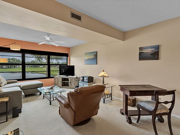 Living space with lake and golf course views
