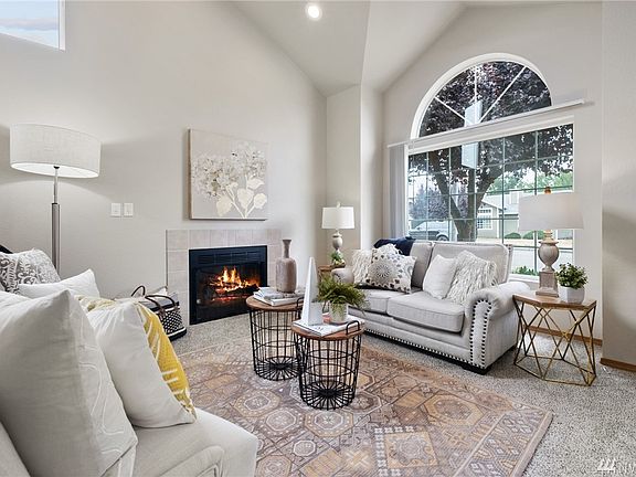 Vaulted ceilings add a spacious feel to the radiant living room, whilst the gas fireplace adds a sense of coziness. 