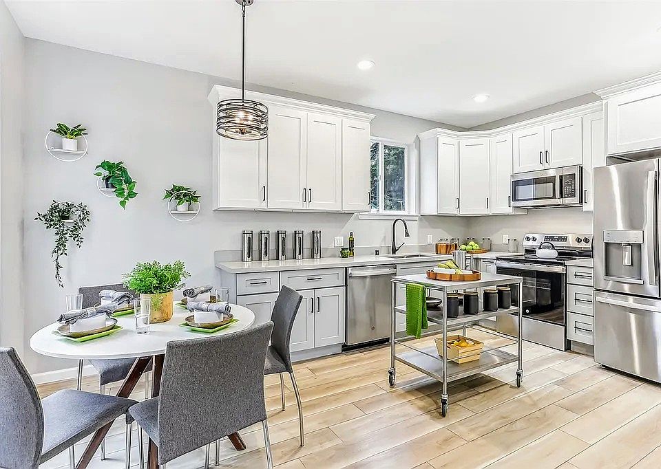 Dining Area and Kitchen with brand new appliances (shown with representative furniture - otherwise unfurnished)