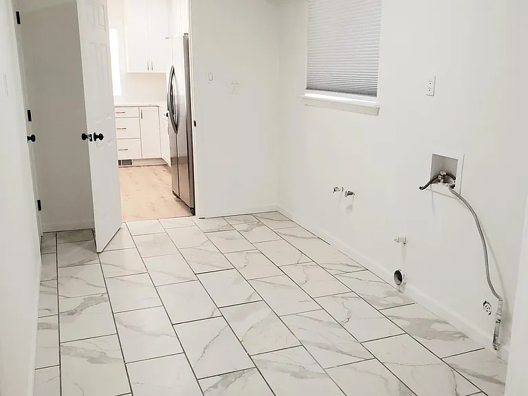Laundry room with door leading down to basement 2-car garage