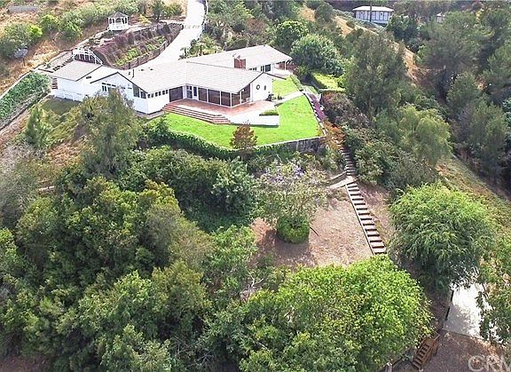 This home is on an especially large lot - bordered by riding/hiking trails on two sides. There's plenty of room for gardens, orchards, vineyards and the corral. A concrete driveway leads to the two stall barn.
