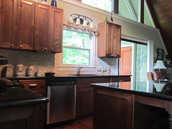 Note the stained cabinetry and granite counter tops.