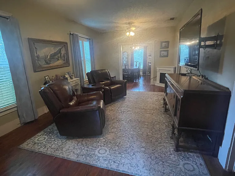 High ceilings, original hardwood floors and classic moldings add space and charm