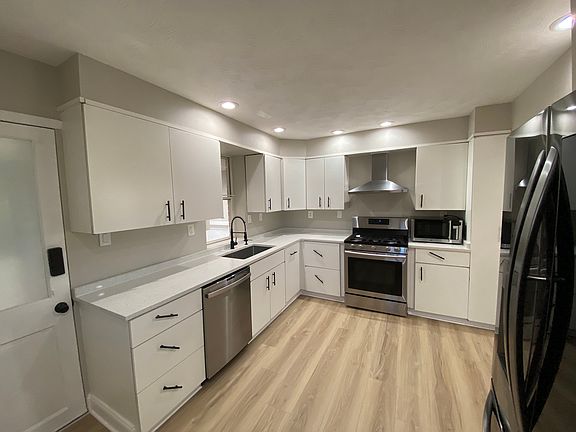 updated kitchen with features such as a brand-new deep sink & garbage disposal, built-in trash/recycle drawer, and microwave