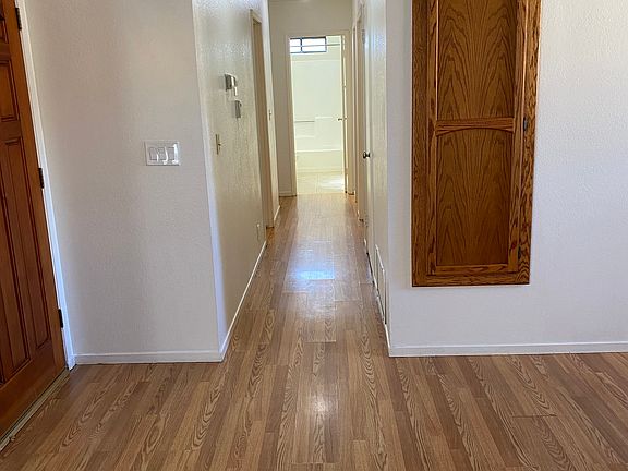 Looking from Livingroom down the hall. Full bathroom at the end of the hall. Three bedrooms off the hall.