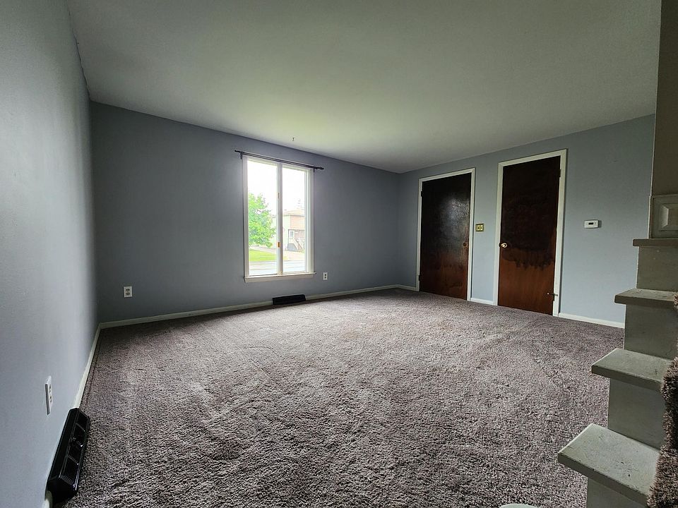 Living room with large coat closet.