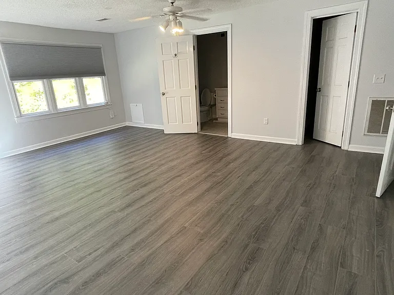 Here is a view of the bedroom with the entrances to the bathroom and the walk-in closet.