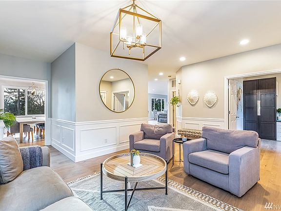 The living room at the entrance welcomes you with recent updates thru-out. Note the premium wide plank flooring that runs the main level of the home.