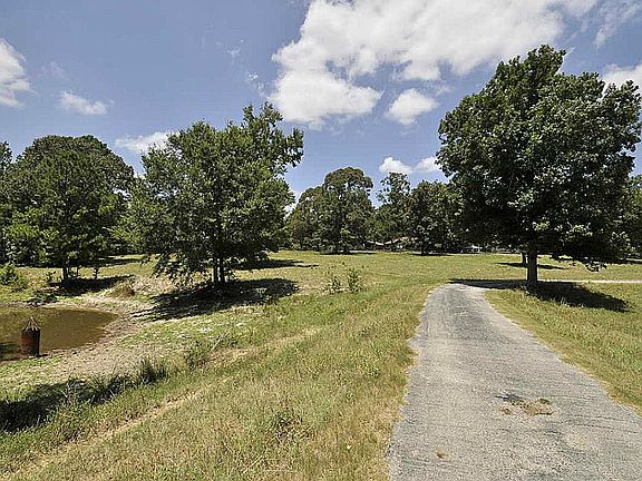 View getting closer to ranch home. Here the road acts as a dam for the pond on the left. Great source of water for livestock!