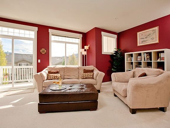Sunny south facing living room with partial mountain views & deck access
