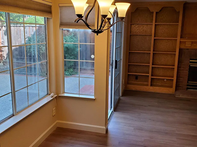 Family room from casual dining area with view of backyard
