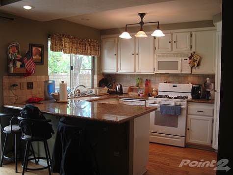 Bright Kitchen With Granite And Wood Flooring!