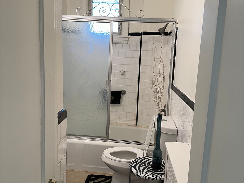 GLASS ENCLOSED TUB SHOWER WITH LINEN CLOSET