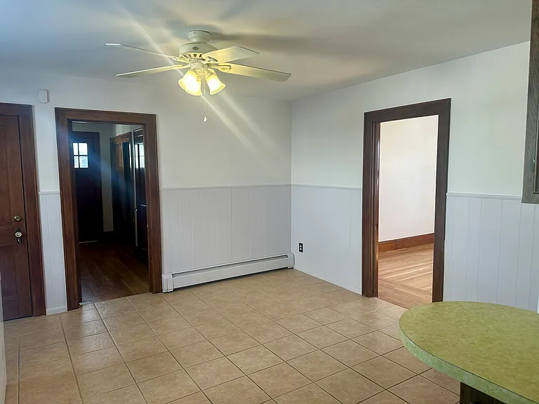 Eat-in kitchen/doors to front entrance, basement and living area on right