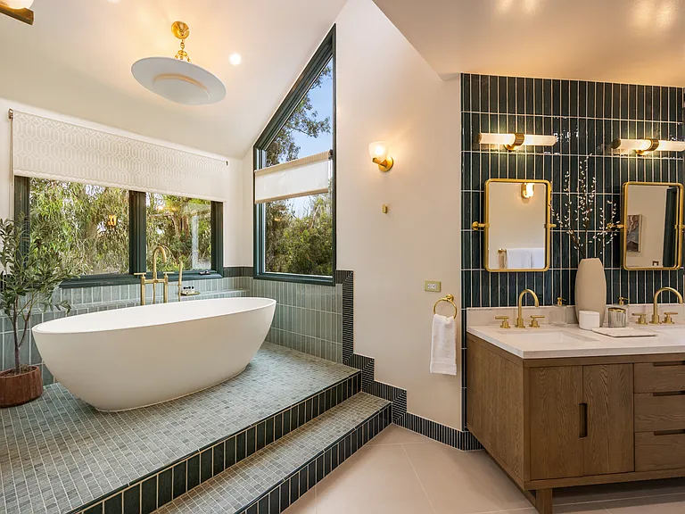Modern design and high-end finishes create a spa-like atmosphere in the primary suite's bathroom.