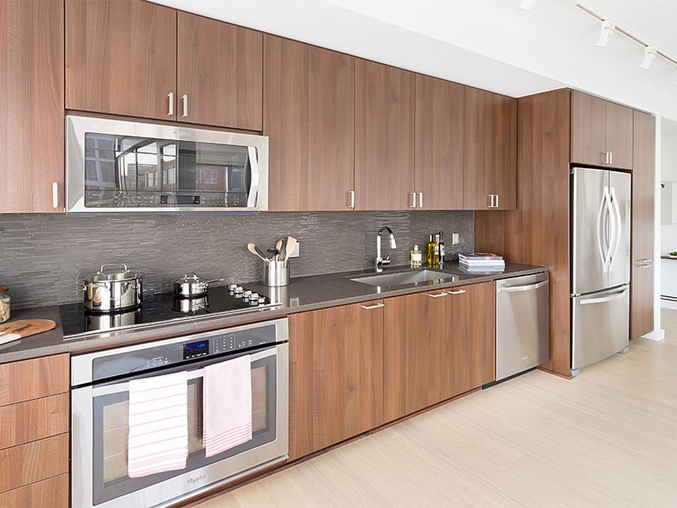 Custom cabinetry with chrome pulls offer ample storage