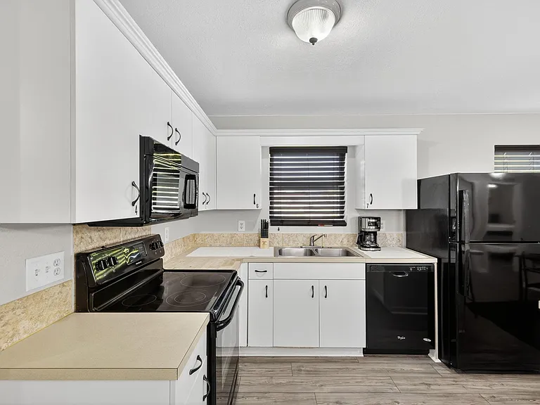 Kitchen is fully equipped with an oven range, microwave, dishwasher, refrigerator / freezer