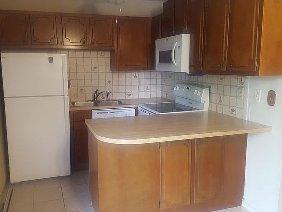 Nice kitchen space with fridge, microwave, stove, and dishwasher. Good cabinet storage.