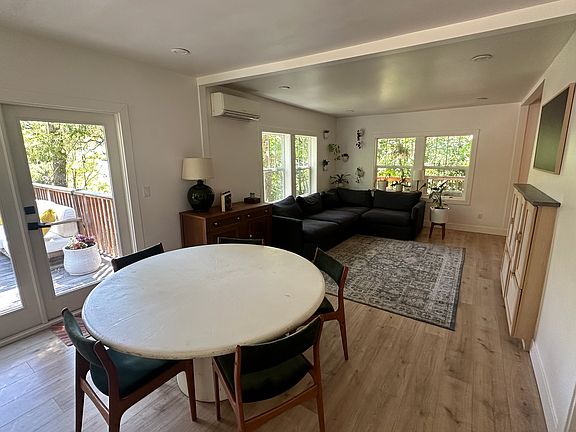 Open living space with large windows and french door access to large deck